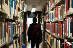 Student Walking Through Library